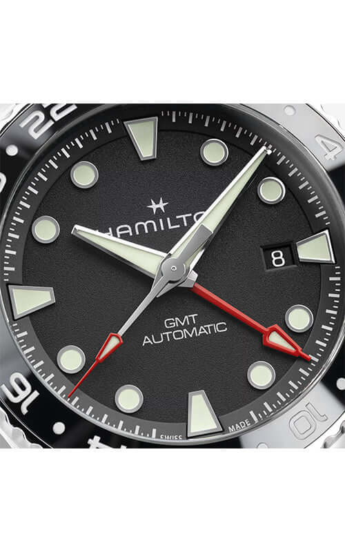 Hamilton watch with black dial and silver bezel on a white background
Hamilton Khaki Navy Scuba GMT H82555330 / Bandiera Jewellers