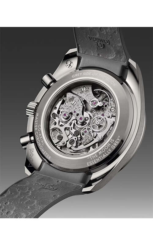 Close-up of a watch with a visible mechanical movement on a gray background
Omega Speedmaster Dark Side of the Moon 310.92.44.50.06.002 Bandiera Jewellers