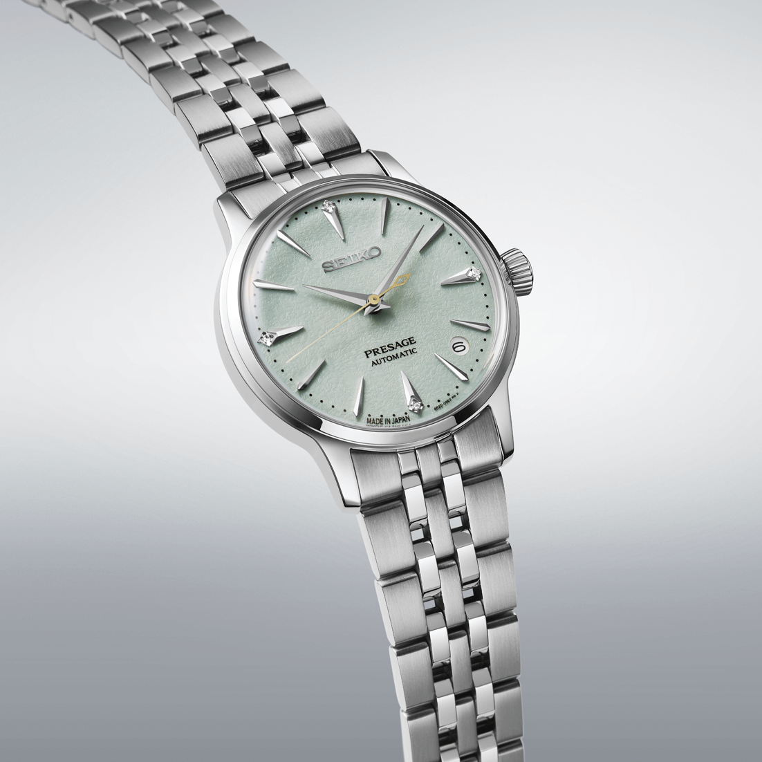 Silver Seiko watch with a light green face on a gray background
Seiko Presage "Cocktail Time" with Diamonds SRPL63J1 Bandiera Jewellers