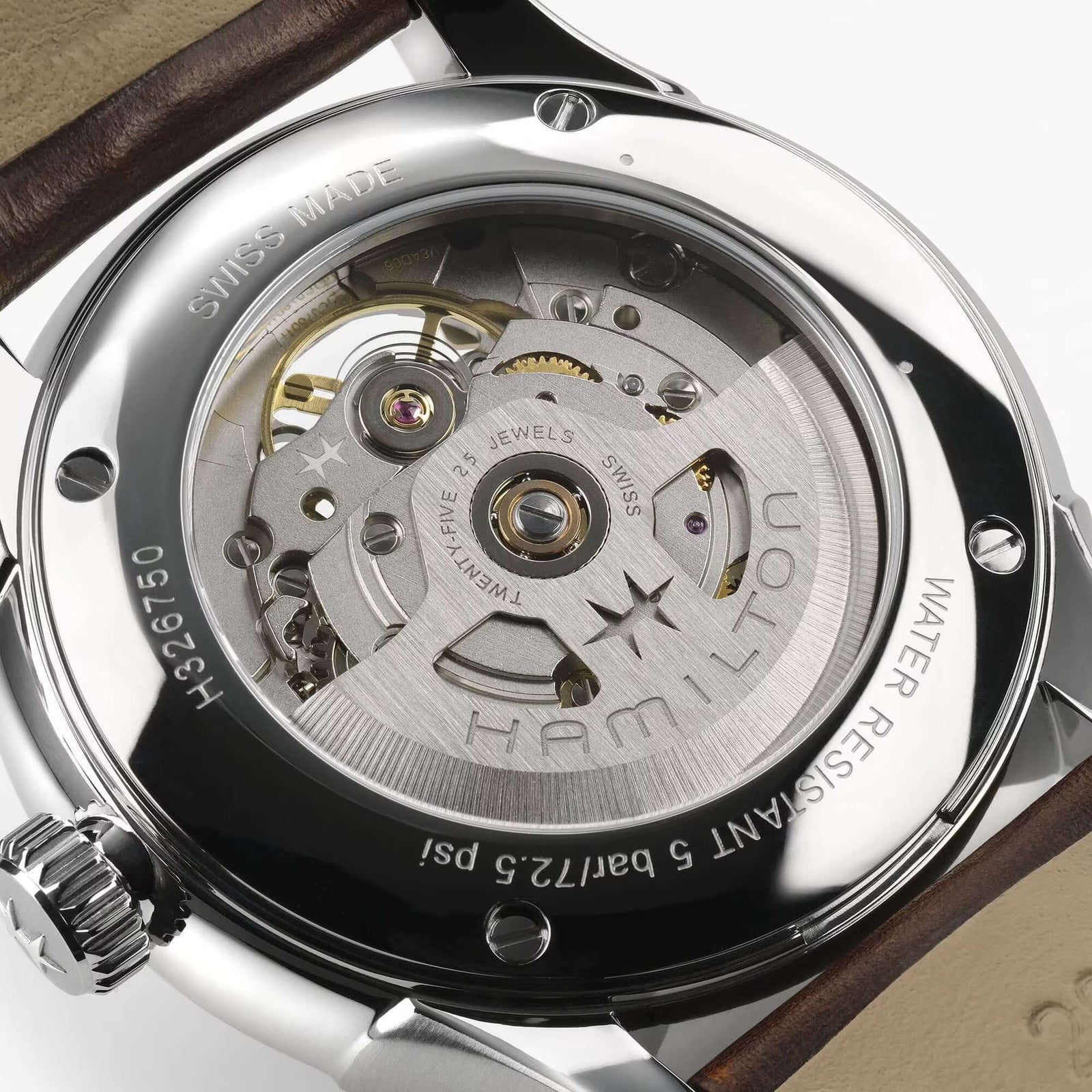 Close-up of a Hamilton watch mechanism with visible branding.
Hamilton Jazzmaster Open Heart Watch H32675501 Bandiera Jewellers