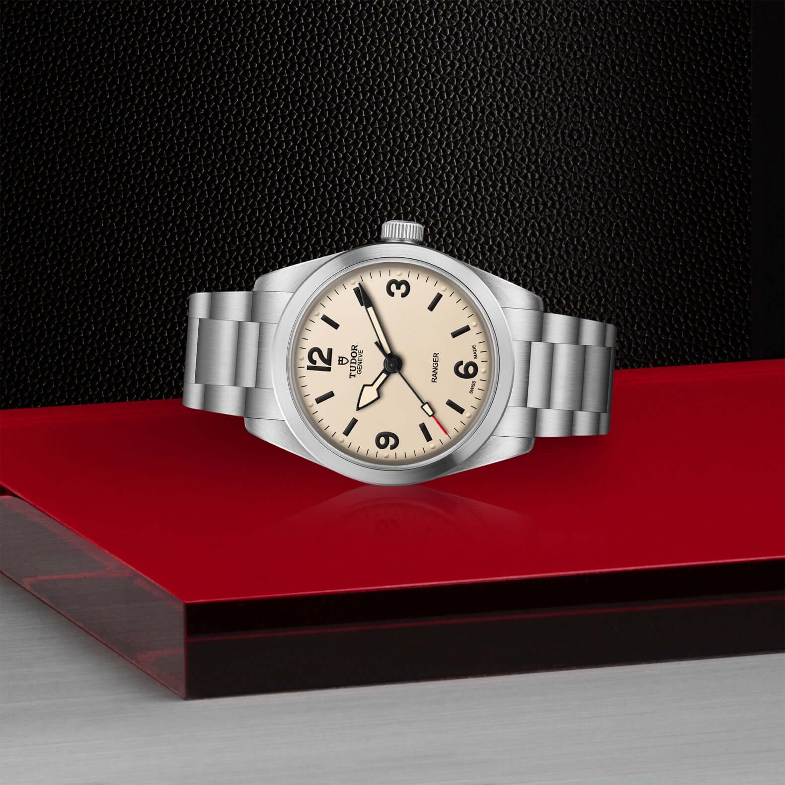 Silver watch with a beige dial on a red and black background
Tudor Ranger M79930-0007 Bandiera Jewellers