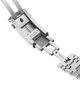 Close-up of a silver watch strap with 'PUSH' label on a black background