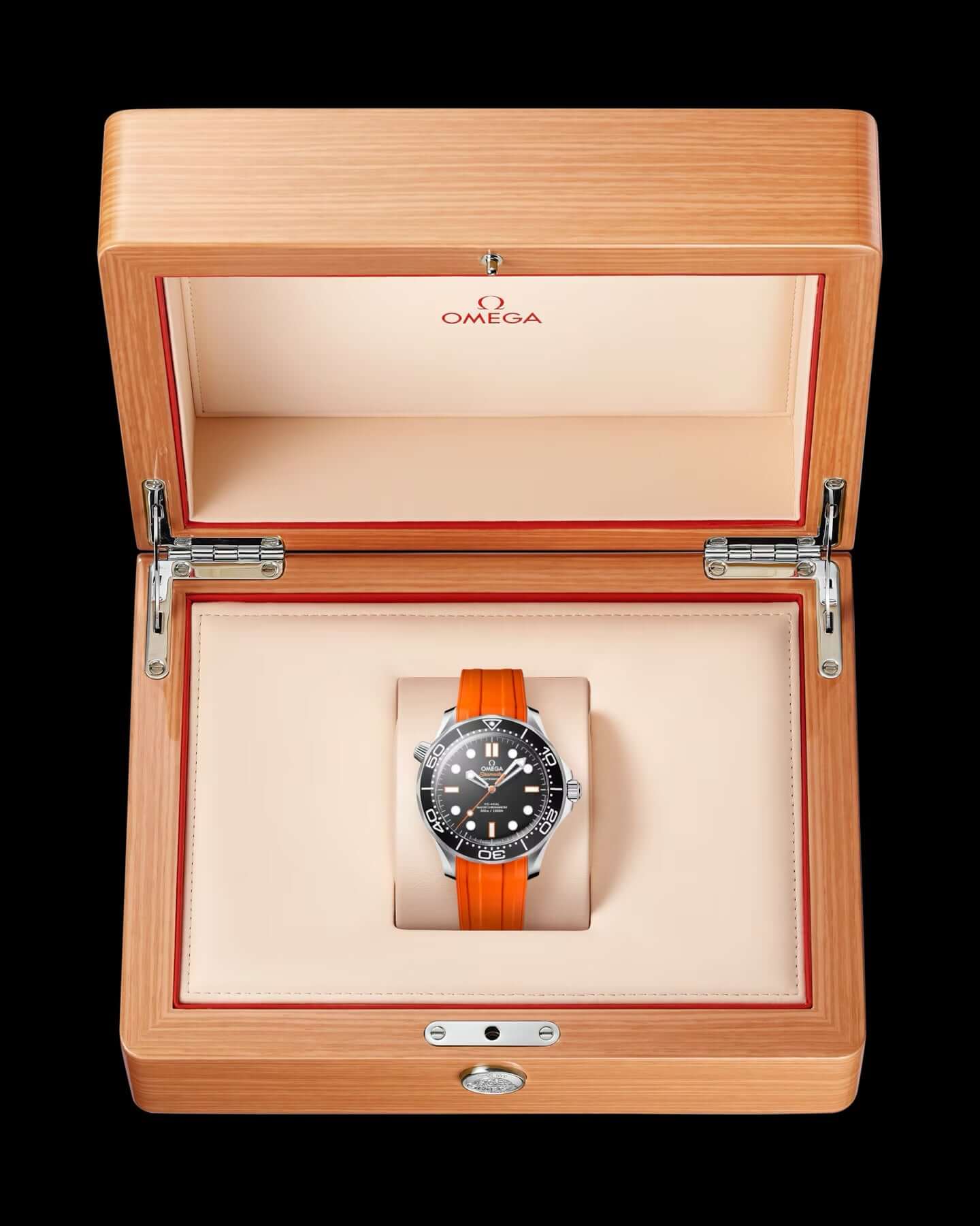 Omega watch with orange strap in a wooden box