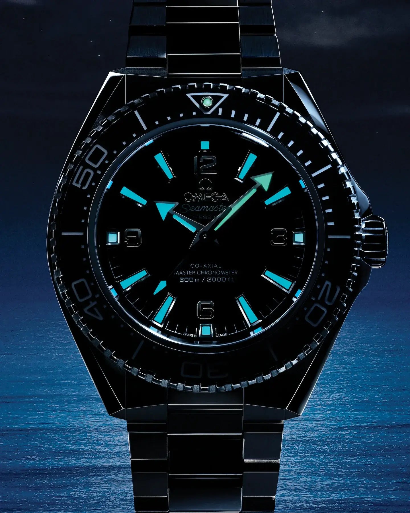 Black Omega watch with blue accents on a dark blue background
Omega Seamaster Planet Ocean 600M 217.30.42.21.01.001 Bandiera Jewellers