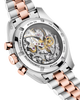 Close-up of a mechanical watch with rose gold and silver band on a black background