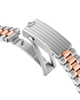 Close-up of a silver and gold watch strap on a white background
