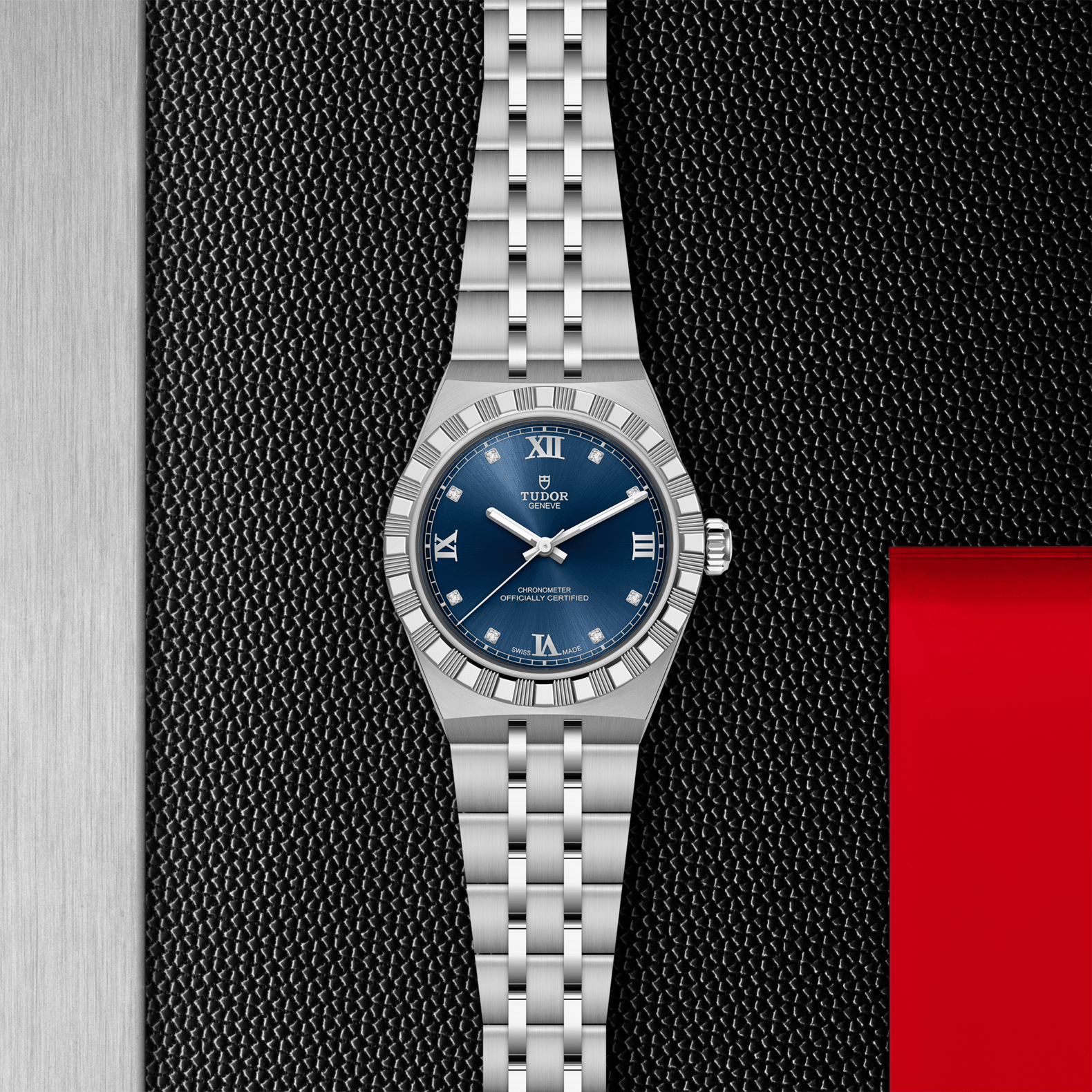 Silver watch with a blue dial on a textured black and red background
Tudor Royal 30mm M2830A1A0-0001 Bandiera Jewellers