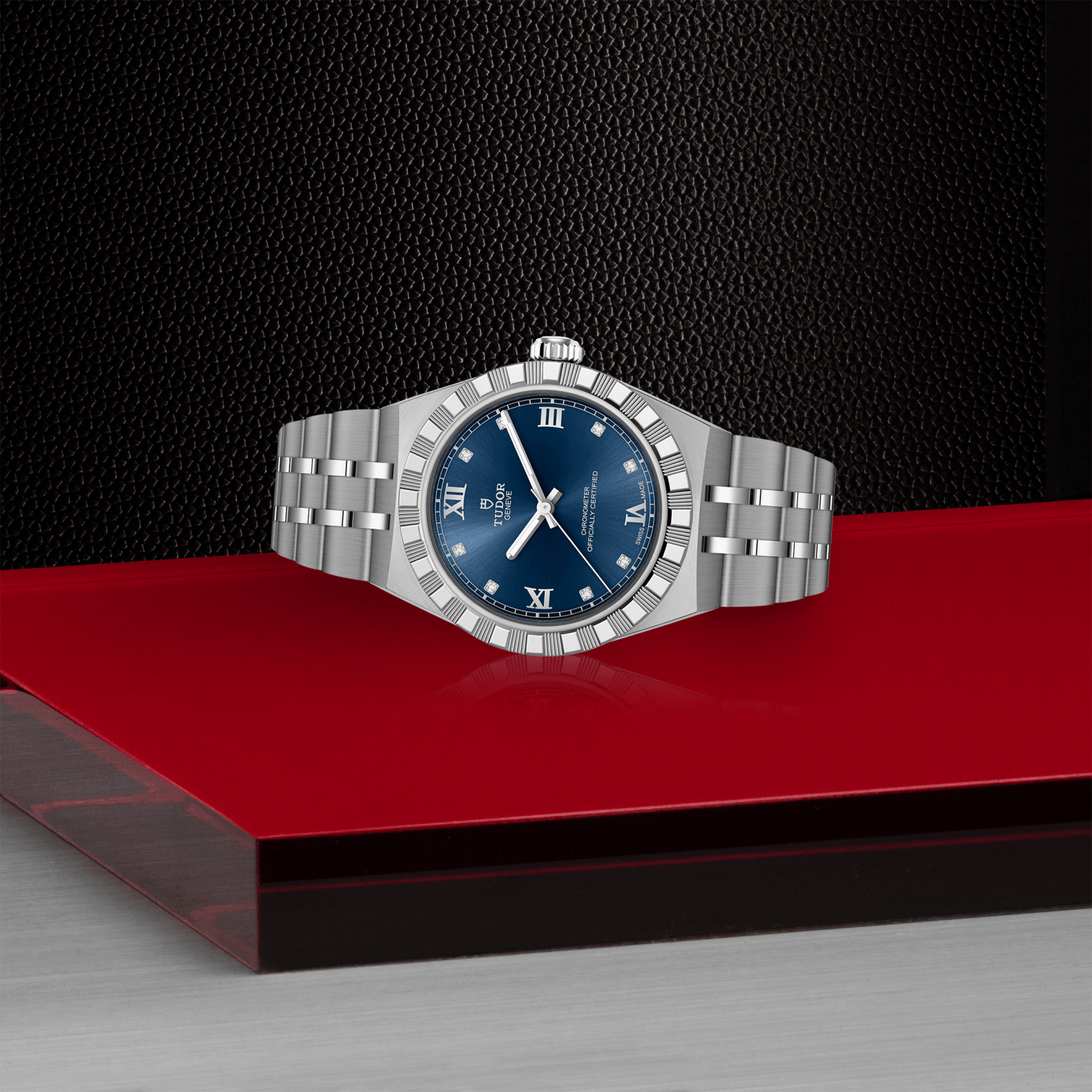 Silver watch with a blue dial on a red platform against a black background
Tudor Royal 30mm M2830A1A0-0001 Bandiera Jewellers