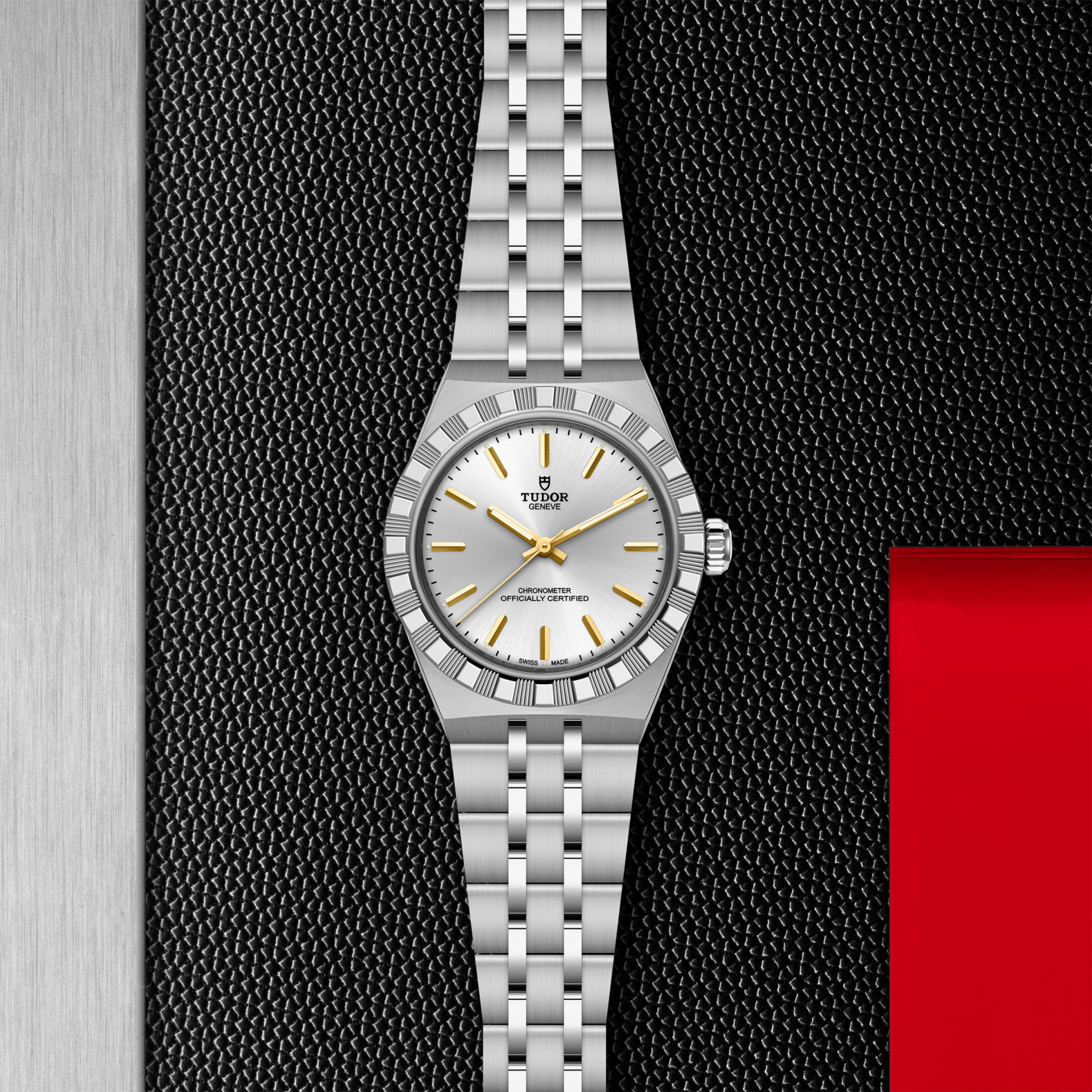 Silver watch with a white face and gold accents on a textured black background
Tudor Royal 30mm M2830A1A0-0002 Bandiera Jewellers