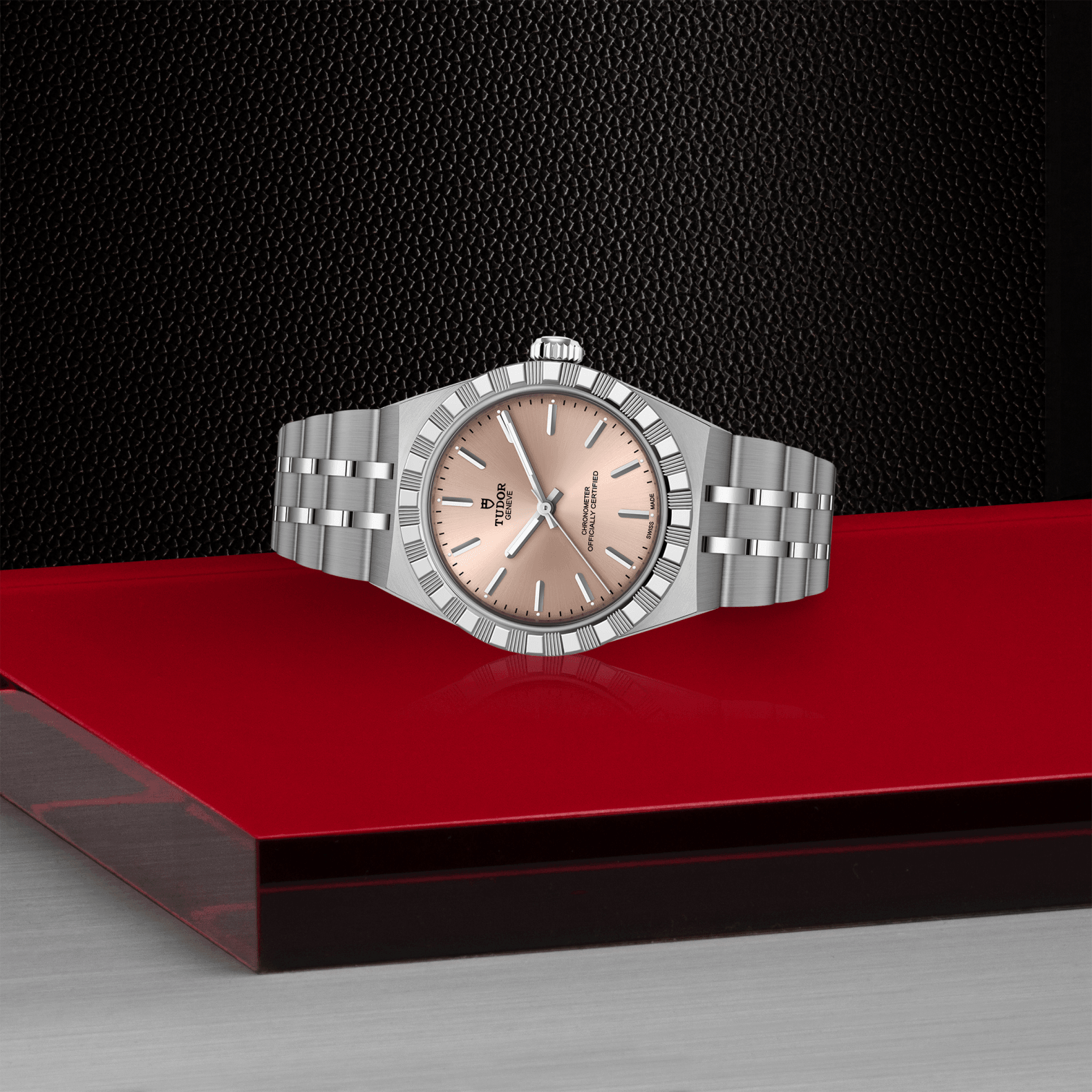 Silver watch with a pinkish face on a red platform against a black background
Tudor Royal 30mm M2830A1A0-0003 Bandiera Jewellers