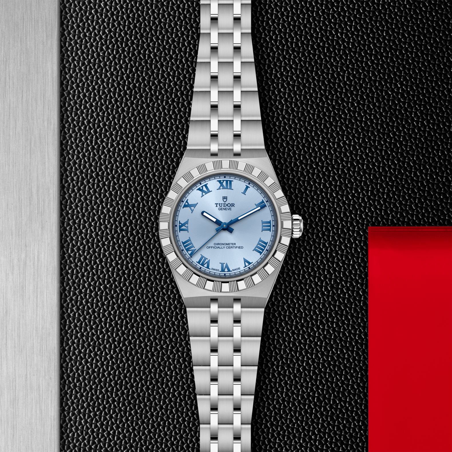 Silver watch with blue face on a textured black and red background
Tudor Royal 30mm M2830A1A0-0004 Bandiera Jewellers