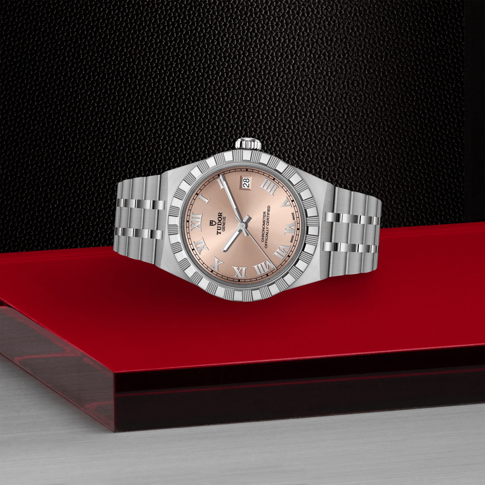 Silver watch with a pink face on a red platform against a black background
TUDOR Royal 36mm M2836C1A0-0105 Bandiera Jewellers