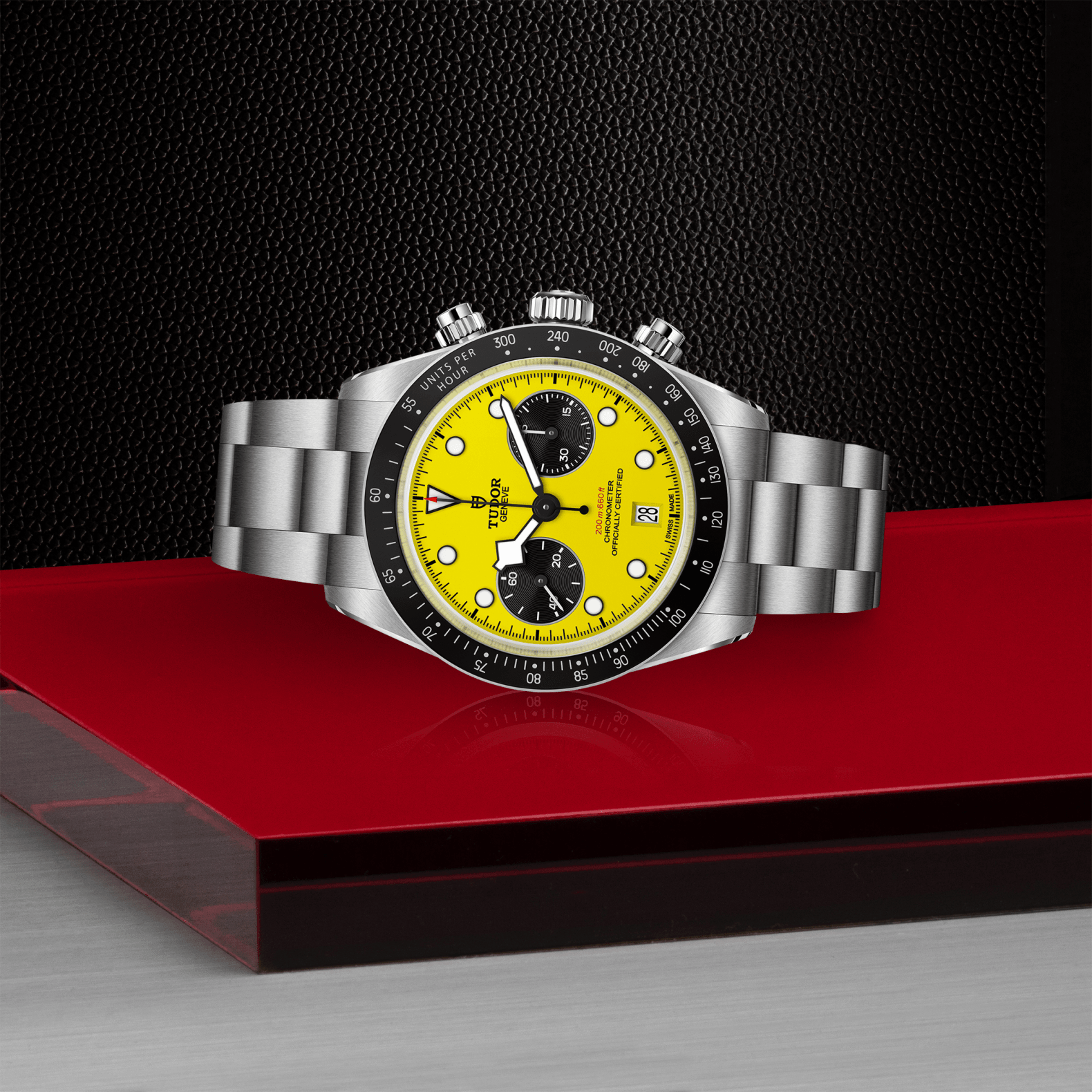 Silver watch with a yellow face on a red platform against a black background
TUDOR Black Bay Chrono 39 M79310N-0001 Bandiera Jewellers