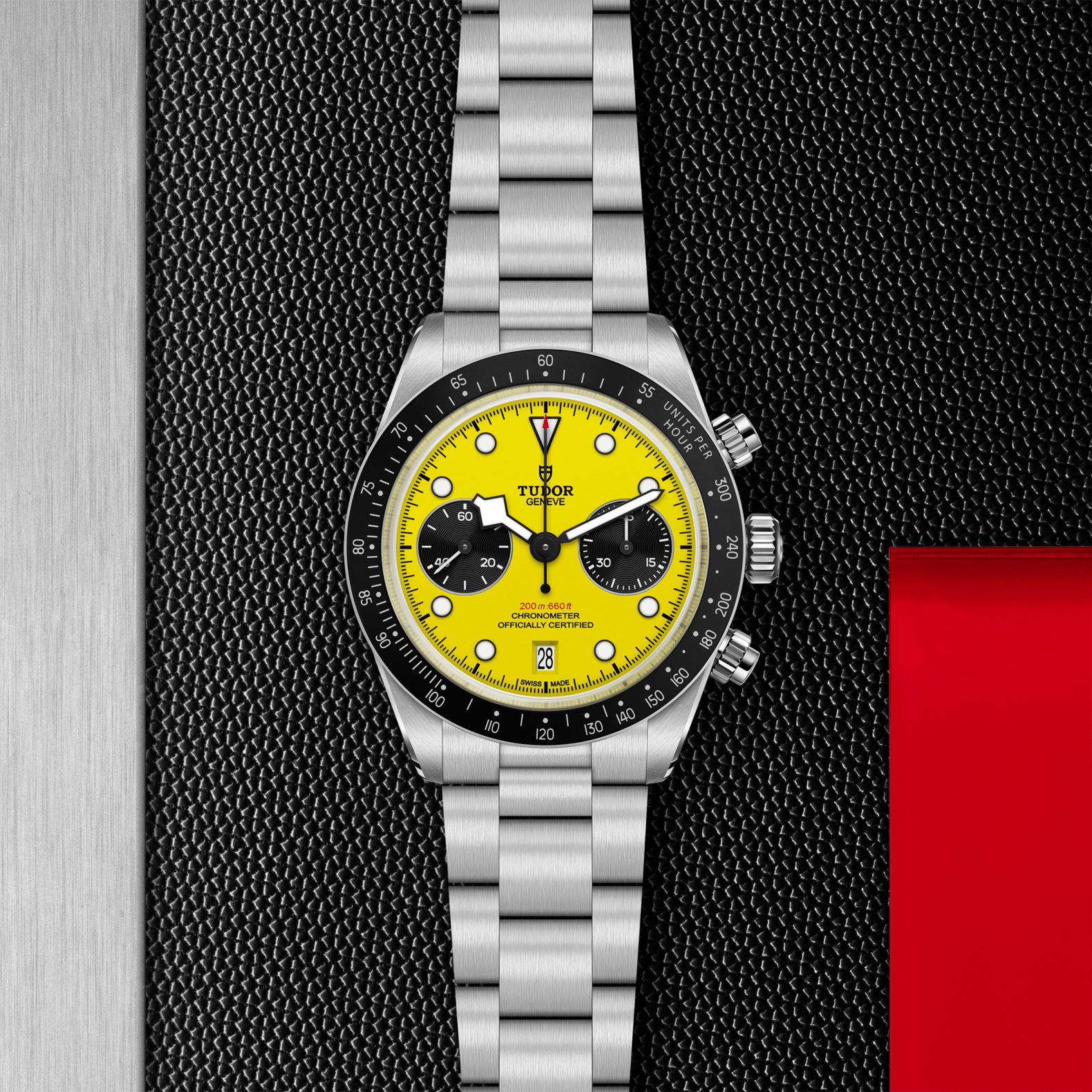 Watch with yellow face and silver bracelet on a textured black background
TUDOR Black Bay Chrono 39 M79310N-0001 Bandiera Jewellers