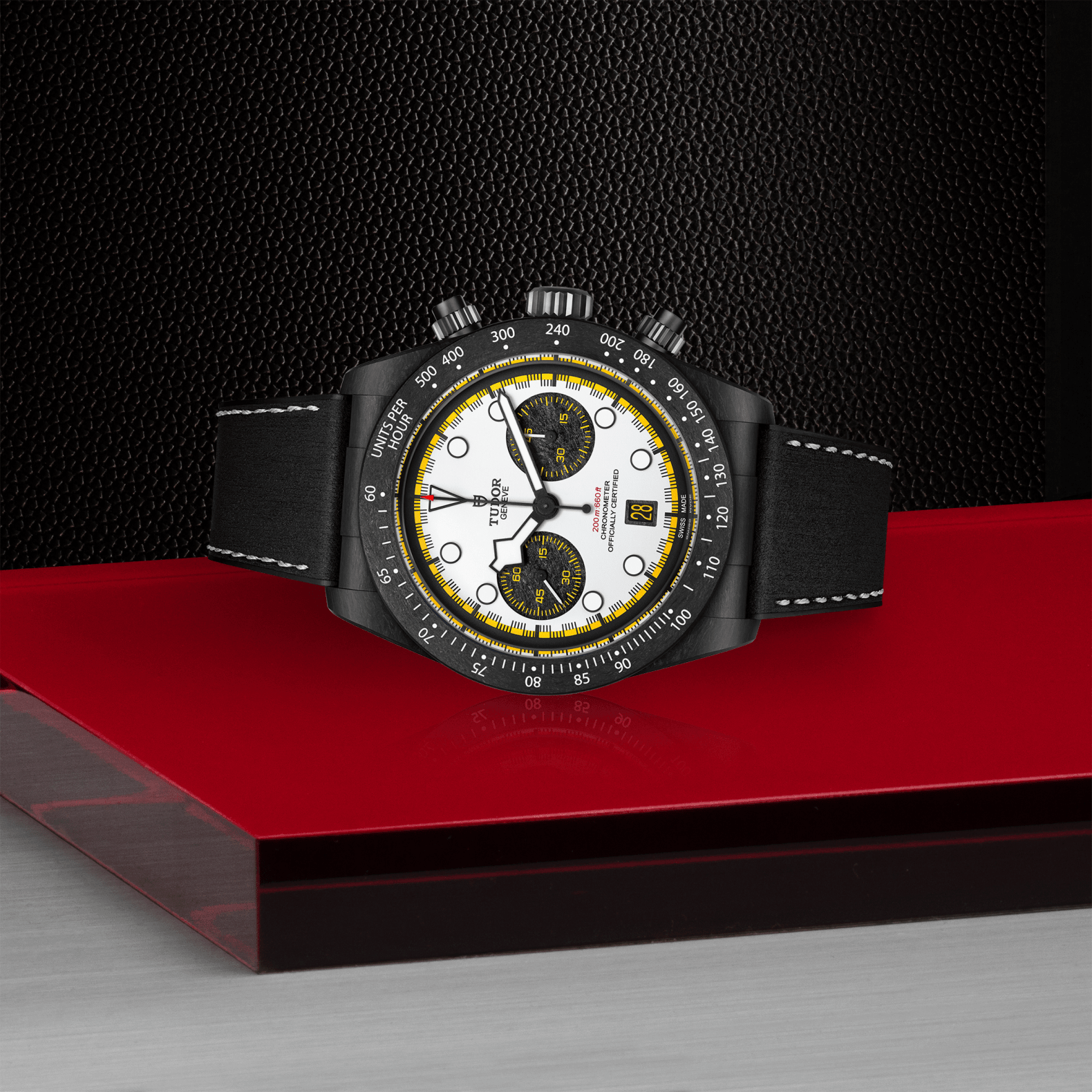 Luxury watch with a black strap on a red platform against a dark background
Tudor Black Bay Chrono “Carbon 26” m79377kn-0003 Bandiera Jewellers