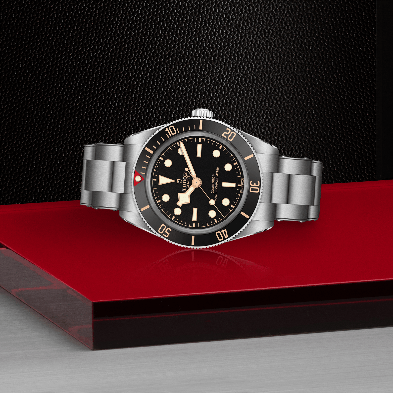 Silver watch with black dial on a red platform against a dark background
Tudor Black Bay 58 M7939A1A0NU-0002 Bandiera Jewellers