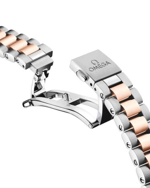 Omega watch strap with rose gold and silver finish on a white background