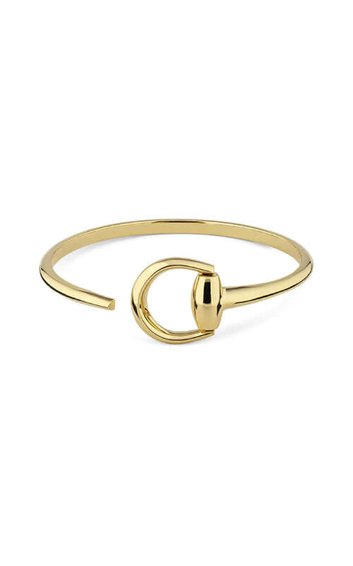 Gold bracelet with a unique design on a white background

GUCCI Horsebit Cuff Bracelet in 18kt Gold YBA837792001 Bandiera Jewellers