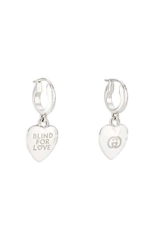 Silver heart-shaped earrings with &#39;Blind for Love&#39; text on a white background

Gucci Blind For Love Hoop Earrings YBD85410600100U Bandiera Jewellers