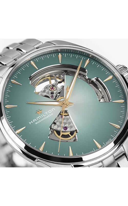 Hamilton watch with green face and visible mechanical components on a white background

Hamilton Jazzmaster Open Heart H32675141 Bandiera Jewellers