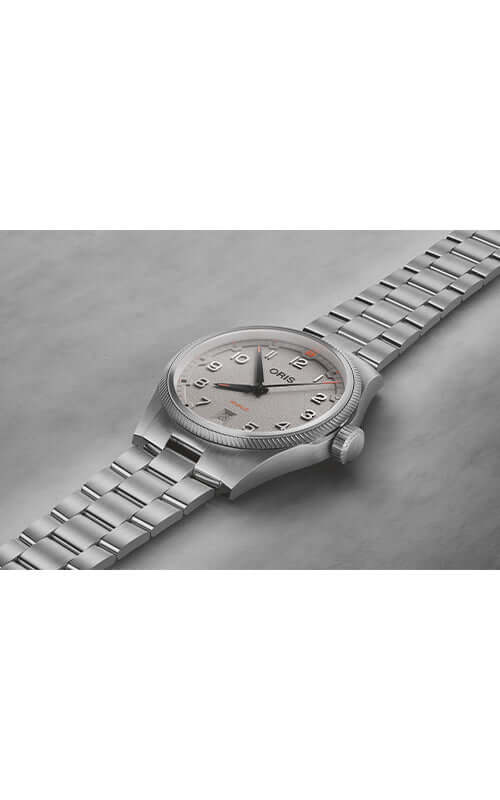 Silver wristwatch with a detailed face on a gray surface

ORIS ProPilot Date 01 733 7805 4163-07 8 20 04LC Bandiera Jewellers