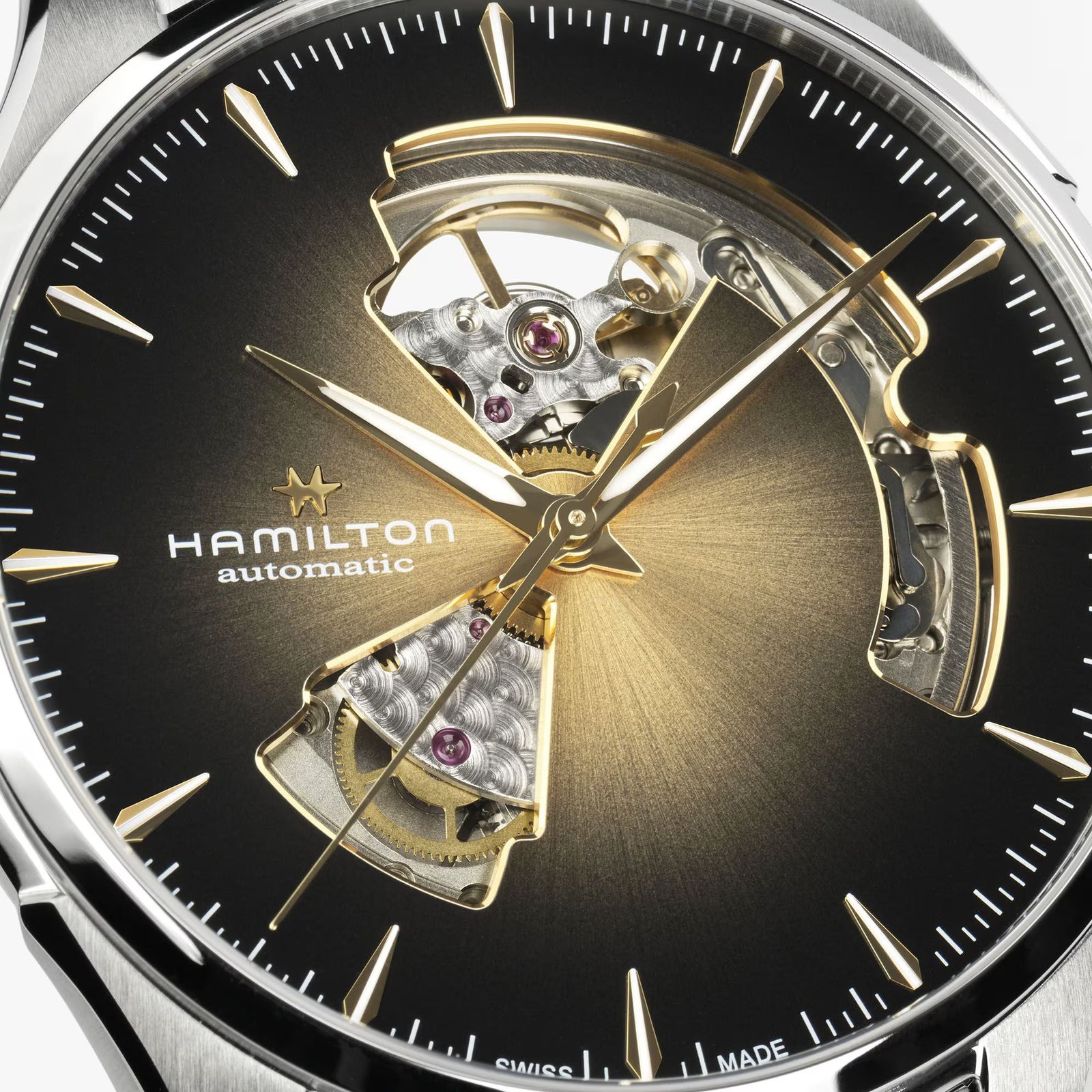 Hamilton watch with open-face design showing mechanical components on a black background

Hamilton Jazzmaster Open Heart Watch H32675501 Bandiera Jewellers