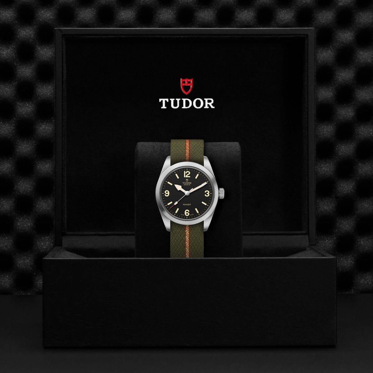 Tudor watch in a black display case with a checkered pattern

Tudor Ranger M79930-0003 Bandiera Jewellers