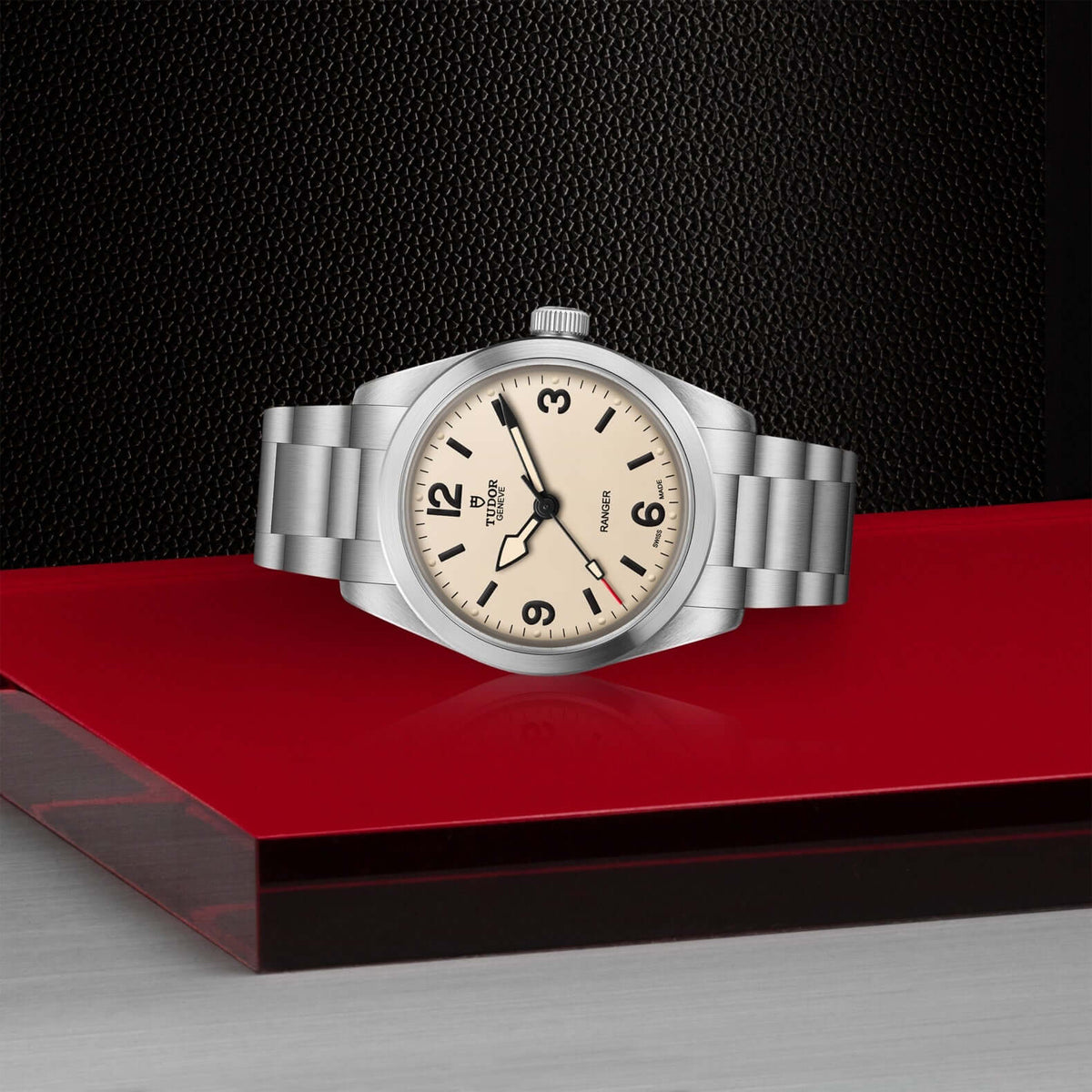 Silver watch with a beige dial on a red and black background

Tudor Ranger M79930-0007 Bandiera Jewellers