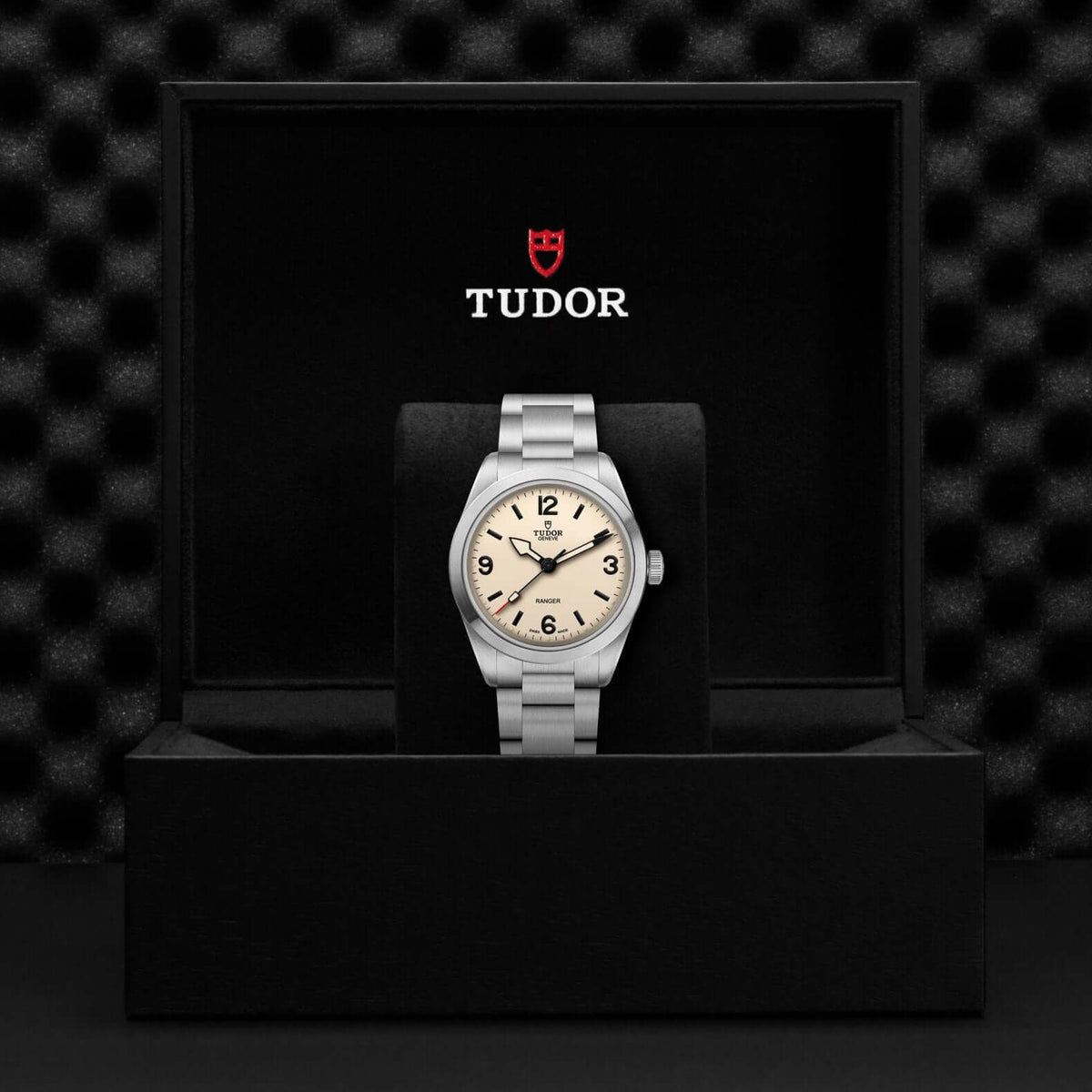 Tudor watch in a black box with the Tudor logo on a dark textured background

Tudor Ranger M79950-0008 Bandiera Jewellers