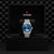 Tudor watch with blue face and silver bracelet in a black box with Tudor logo.

Tudor 1926 Luna M91560-0002 Bandiera Jewellers