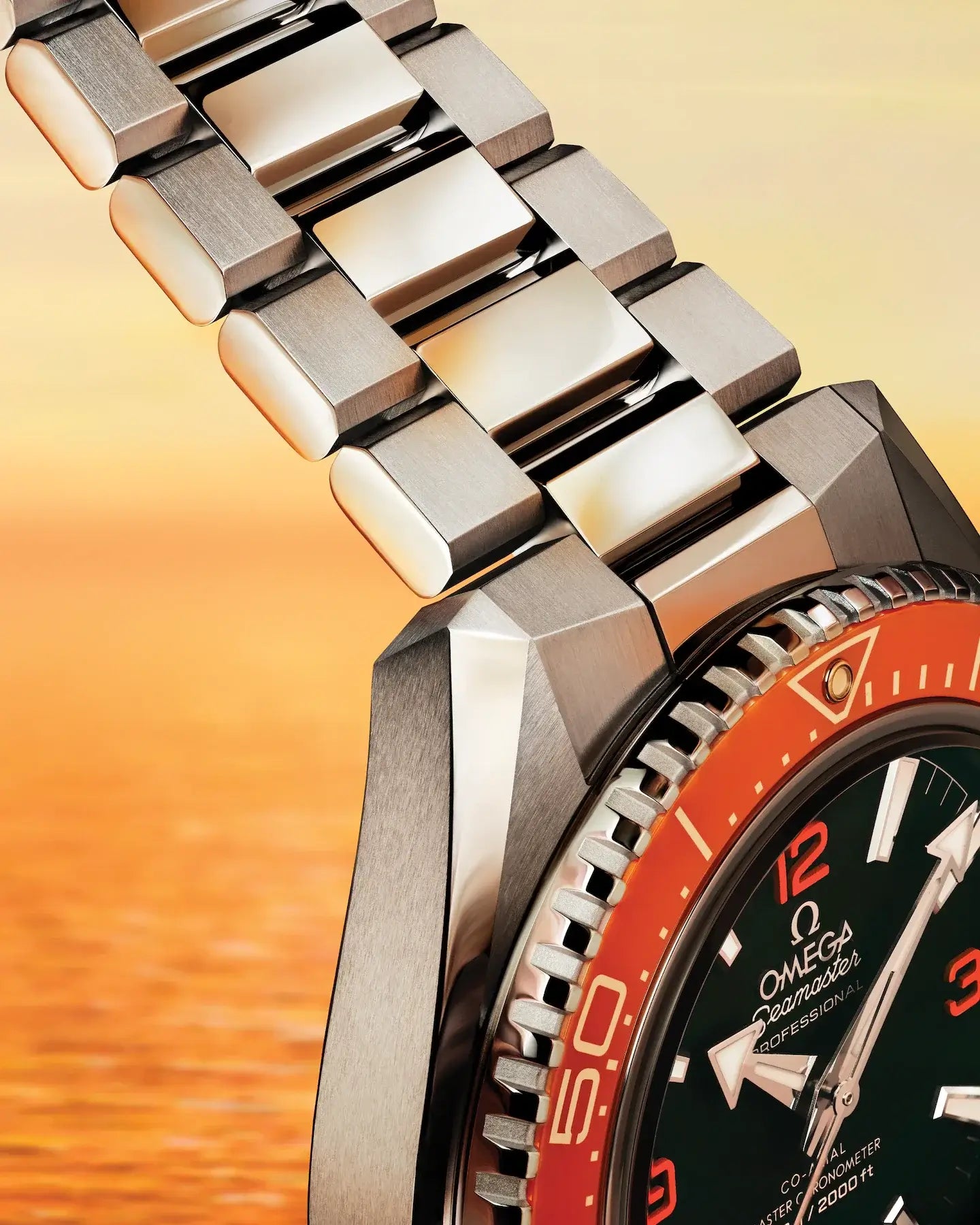 Close-up of a silver watch with a red bezel and black dial on an orange gradient background.

Omega Seamaster Planet Ocean 600M 217.30.42.21.01.003 Bandiera Jewellers