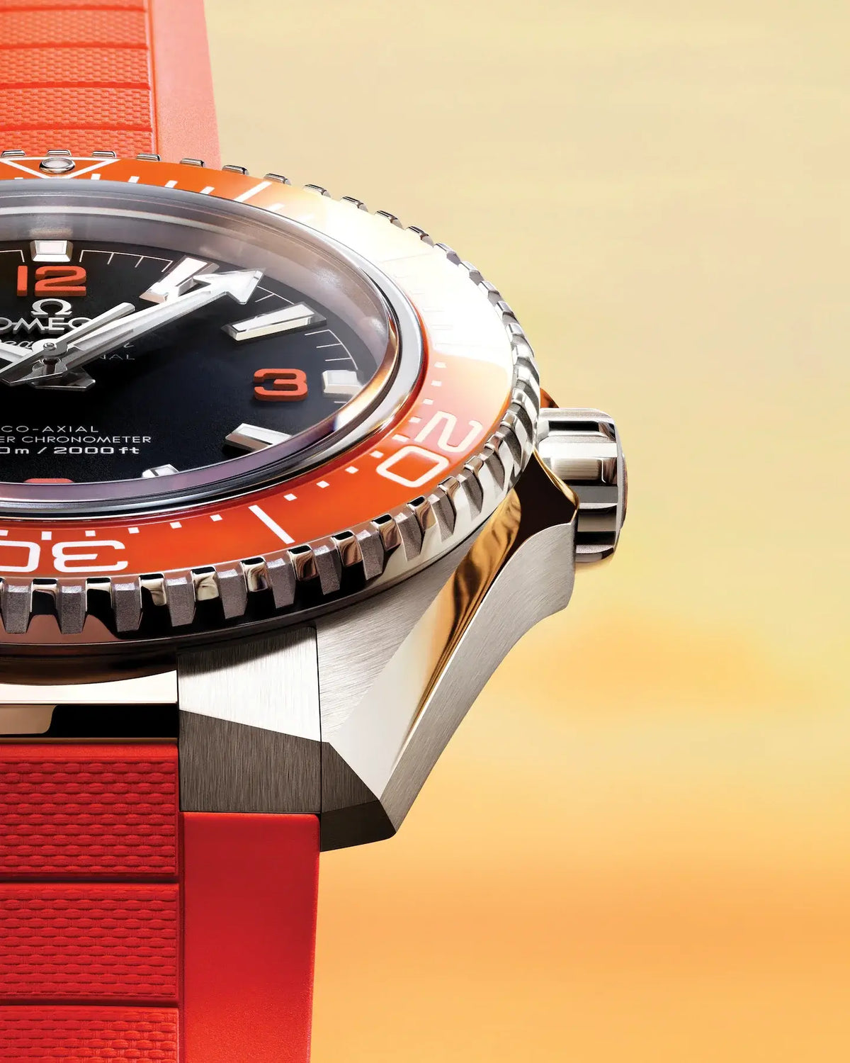 Close-up of a watch with a red strap and orange bezel on a gradient background

Omega Seamaster Planet Ocean 600M 217.32.42.21.01.004 Bandiera Jewellers
