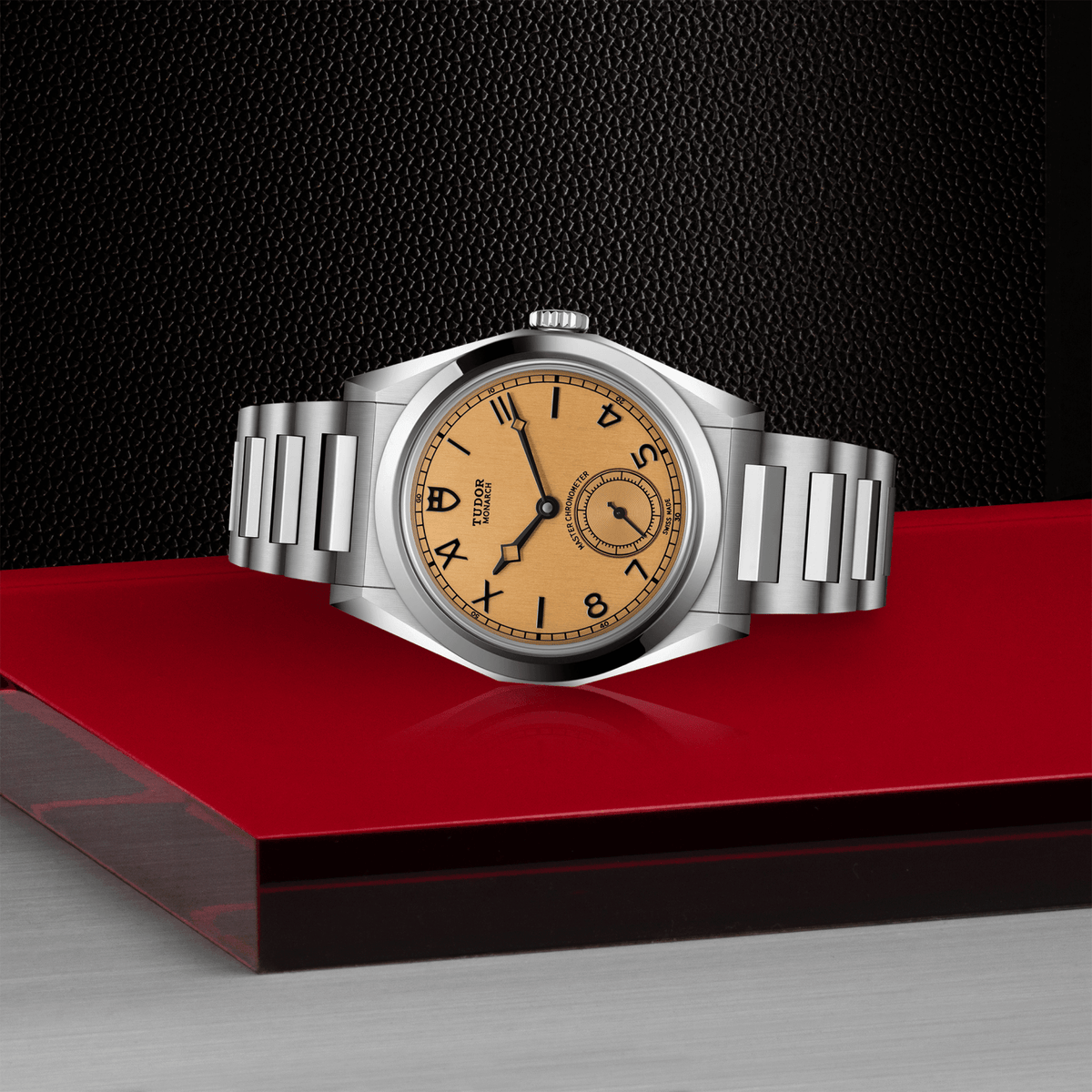 Silver watch with a brown face on a red platform against a black background

Tudor Monarch M2639W1A0U-0001 Bandiera Jewellers