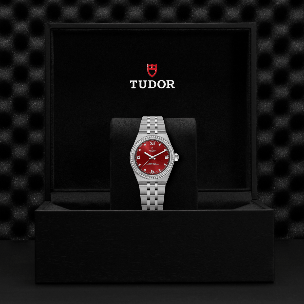 Tudor watch with red face and silver case on a black stand against a black textured background

Tudor Royal 30mm M2830A1S0-0002 Bandiera Jewellers