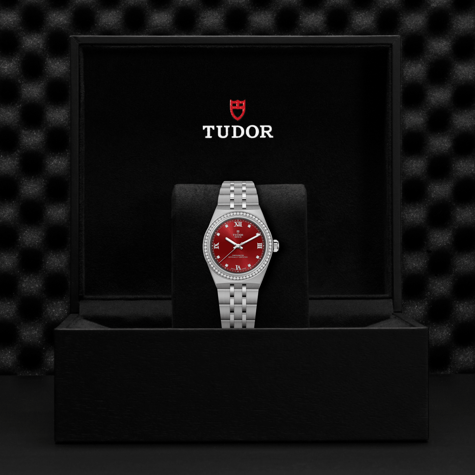 Tudor watch with red face and silver case on a black stand against a black textured background

Tudor Royal 30mm M2830A1S0-0002 Bandiera Jewellers