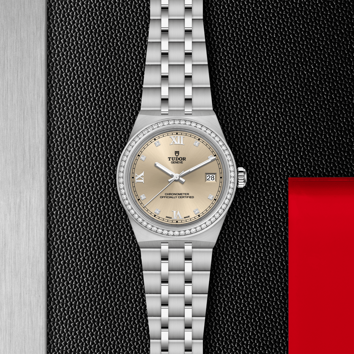 Silver Tudor watch with a beige dial on a textured black background

Tudor Royal 36 M2836C1S0-0001 Bandiera Jewellers