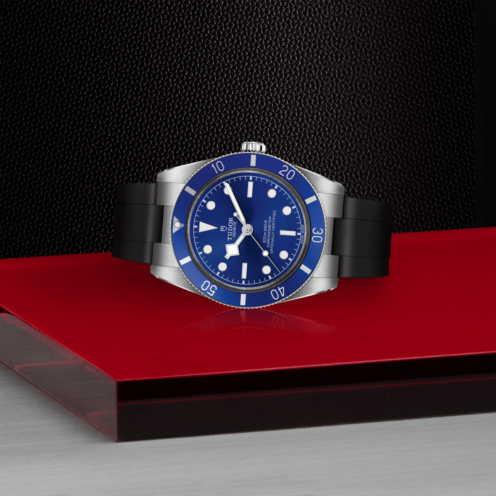 Wristwatch with blue dial and black strap on a red platform against a dark background

Tudor Black Bay 54 M79000B-0002 Bandiera Jewellers