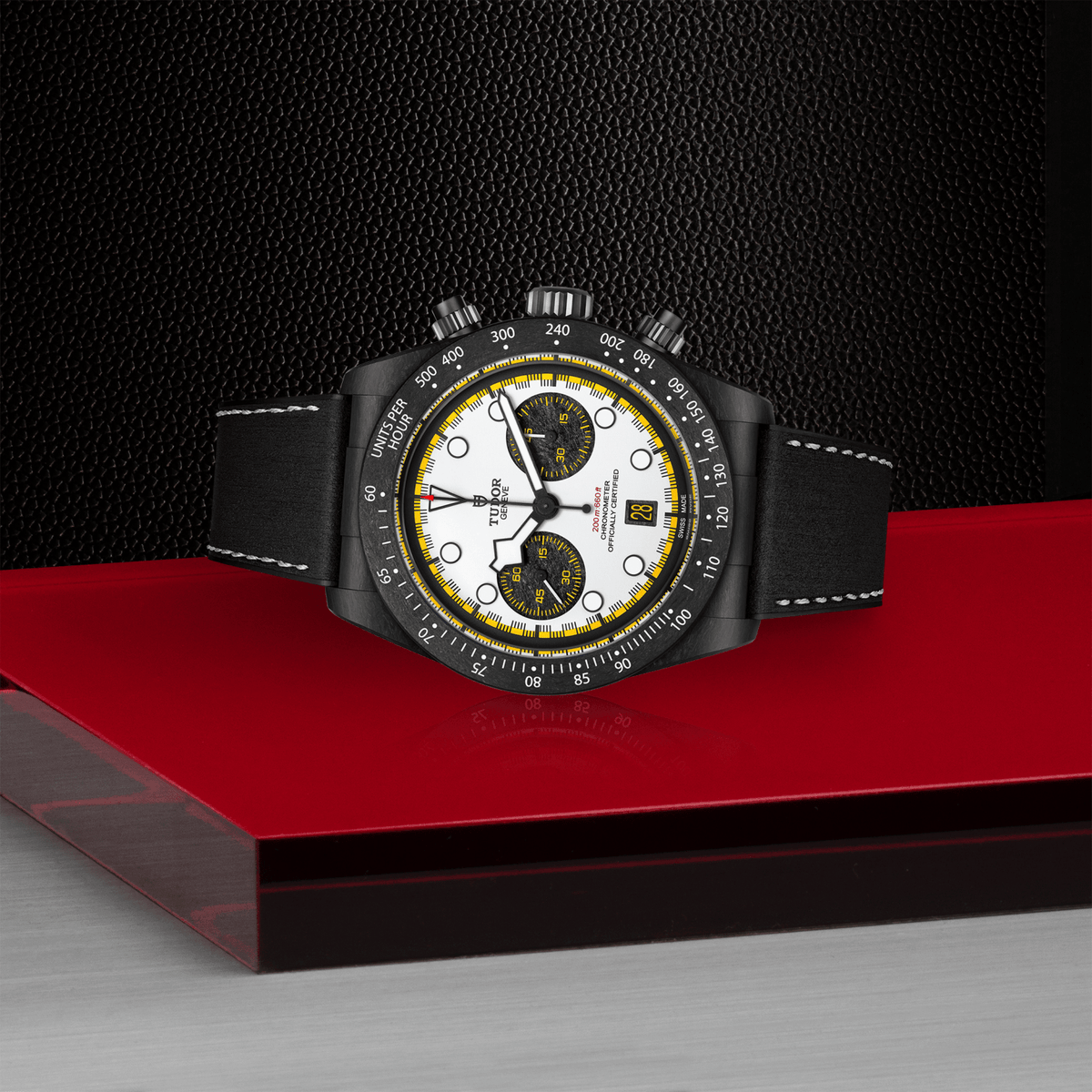 Luxury watch with a black strap on a red platform against a dark background

Tudor Black Bay Chrono “Carbon 26” m79377kn-0003 Bandiera Jewellers