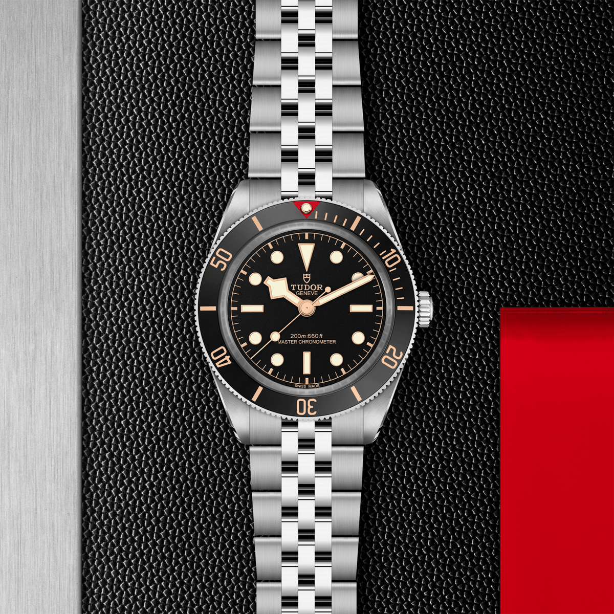 Silver watch with black dial on a textured black background

Tudor Black Bay 58 M7939A1A0NU-0001 Bandiera Jewellers