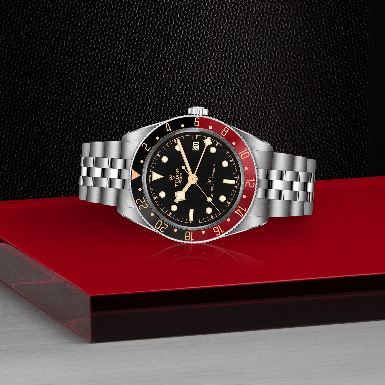 Watch with a silver band and black and red face on a red platform with a dark background

Tudor Black Bay 58 GMT M7939G1A0NRU-0003 Bandiera Jewellers